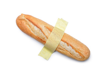 A loaf of bread glued with yellow tape to a white surface. Modern pop-art.