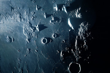 The surface of the moon, with craters and mountains. Elements of this image were furnished by NASA.