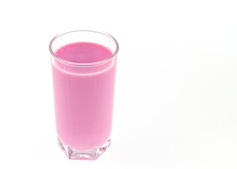 Close-up of pink fruit milk yogurt in a transparent glass of a glass for design on a white background