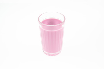 Close-up of pink fruit milk yogurt in a transparent glass of a glass for design on a white background