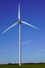 Wind turbine in summer day up Colorful blue sky Alternative energy concept