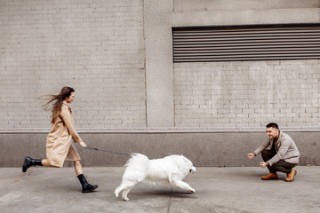 Attractive beauty couple with white dog
