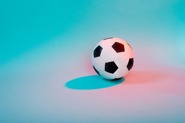 Fototapeta na wymiar Soccer ball isolated on blue neon background