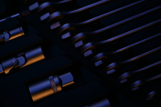 auto car chrome toolbox kit with socket wrench tool lit with blue and warm yellow light on dark luxury background in workshop repair service