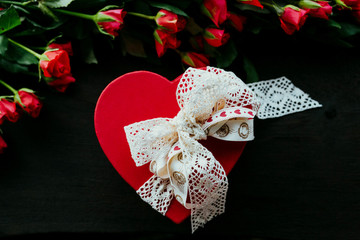 red box in heart shape with white bow roses