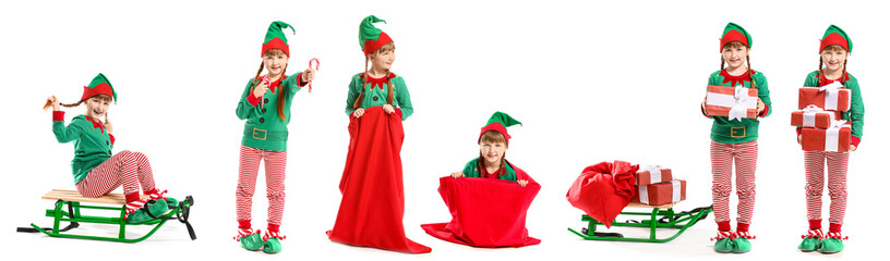 Little girl in costume of elf sitting on sledge against white background
