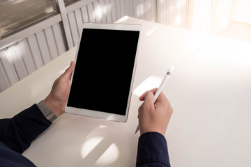 businessman works on the tablet,holding tablet in hand.