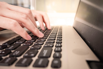 Man working at home office hand on keyboard close up