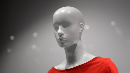 Bust a white mannequin in a red T-shirt over a grey background.
