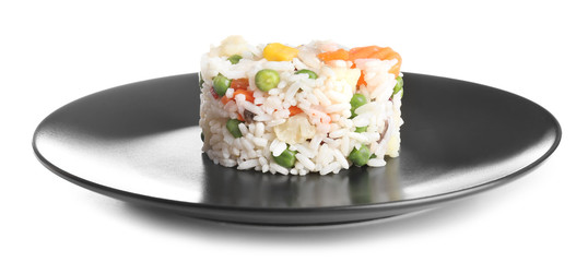 Plate with boiled rice and vegetables on white background
