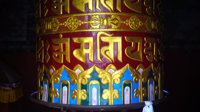 Large prayer wheel in buddhist temple near Namobuddha