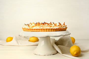 Dessert stand with tasty lemon pie on table