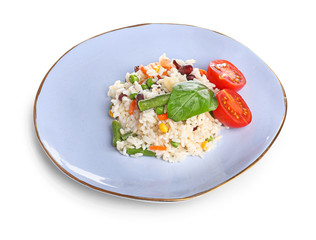 Plate with boiled rice and vegetables on white background