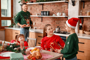 Son greeting his mother on Christmas during dinner