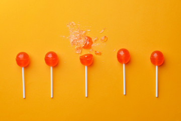 Tasty lollipops on color background