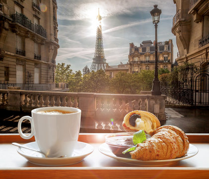Coffee with croissants against famous Eiffel Tower in Paris, France
