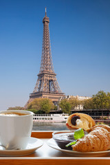 Coffee with croissants against famous Eiffel Tower in Paris, France