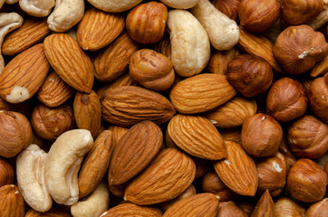 Nuts pile background. Scattered nut on table top view. Nut texture.