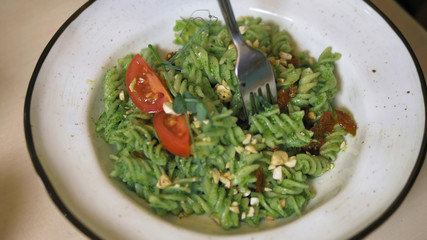 fashionable design food. vegetarian pasta with green sauce and cashew nuts