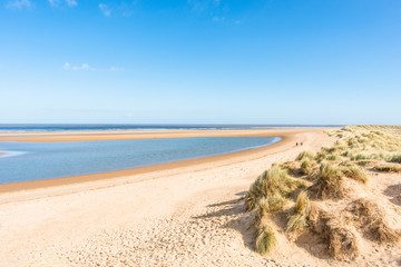 Sand dunes where Norfolk Coast path National Trail from Barnham Overy Staithe reaches the sea,...