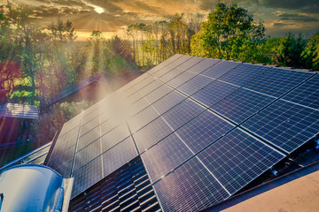 Solar panels and sunlight reflextions on the roof against blue sky background. Concept clean power...