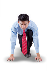 Businessman in ready position to run