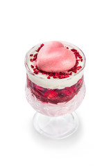 original creamy dessert with strawberries and pink mousse heart in a glass goblet. Cupcake for Valentine's Day. refreshment. White background. isolated