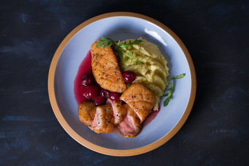 Duck breast with cherry wine sauce and mashed potato. View from above, top view