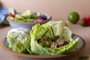 Stuffed iceberg lettuce leaves with turkey and vegetables on blue plate. Healthy diet food