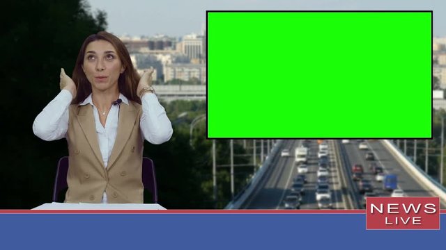 Female news presenter in broadcasting studio with green screen display for mockup usage