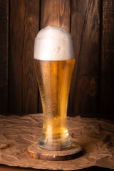 Glass beer on wood background.