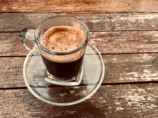 Close up coffee cup on wood table. Dramatic warm concept. 