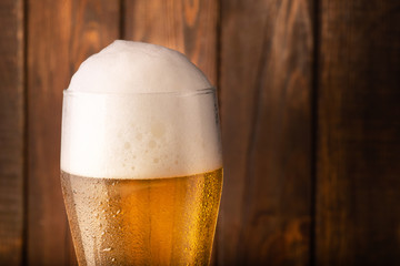 Glass beer on wood background.