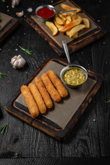 The Best Snacks for beer. Cheese sticks, chicken snacks, fried potatoes and balls, black bread with garlic and squid. Octoberfest party dinner. Festive table with delicious mediterranean food.