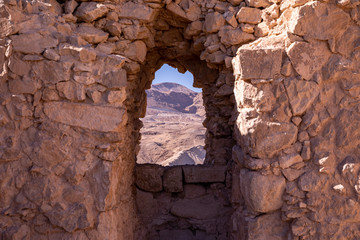A view trough an opening in a stone wall.