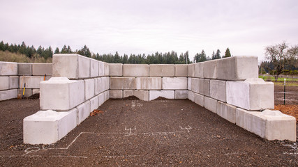 Construction of a manure storage system made of a large heavy concrete blocks.