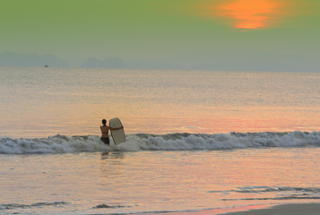 Tourists are surfing on the beaches of Thailand.