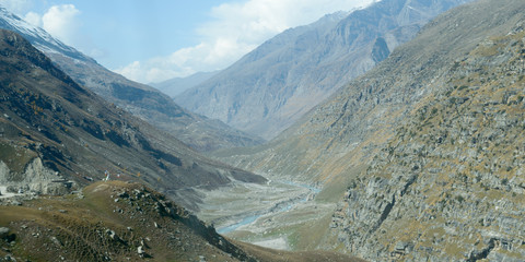 V-shaped Himalayas valley down which a river with a winding course flows. An interlocking...