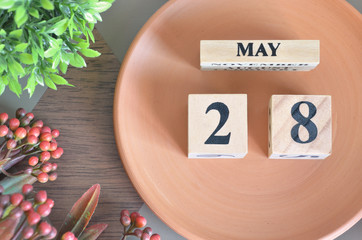 May 28, month design with flower and earthenware.