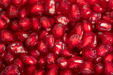 Ripe red pomegranate seeds close up, to view , seamless background