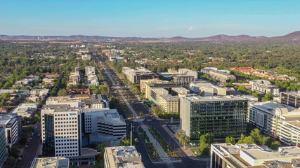 Fototapeta na wymiar Panoramic aerial view of Canberra City, the capital of Australia, looking north over Northbourne Avenue on a sunny afternoon 