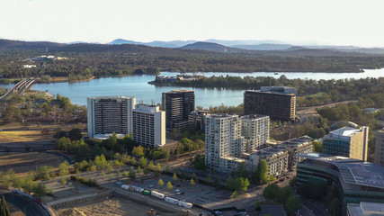 Aerial view of Canberra City, the capital of Australia, looking south toward Lake Burley Griffin and Commonwealth Bridge on a sunny afternoon  