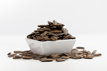 bowl of sunflower seeds isolated on white background