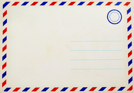 empty postcard made of old paper with space for the address and your text and a blue ink stamp in the corner