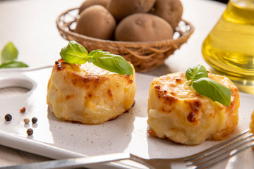 Small casseroles made from potatoes and cheese