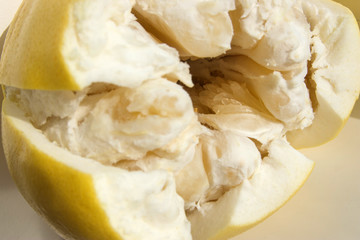 partially peeled Pomelo fruit close-up