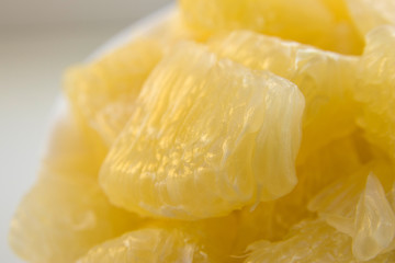 juicy peeled pomelo fruit close-up macro