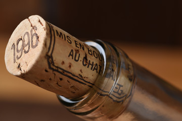 Closeup of a wine cork and the neck of a wine bottle. Mis en Bouteille au Chatueau translates to Bottled at the Chateau. © Steve Cukrov