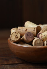 Closeup of a wooden bowl full of used wine corks. Vertical with copy space.