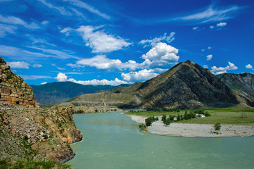 Naklejka na ściany i meble Beautiful view of bend in Katun river with blue bky and clouds in the Altai mountains. Amazing landscape of the river and high mountains in sunny summer day.